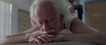Movie still from “Breakin' All the Rules” (2004), directed by Daniel Taplitz – An old man with white hair and a white beard is sleeping; Close Up shot, Low angle