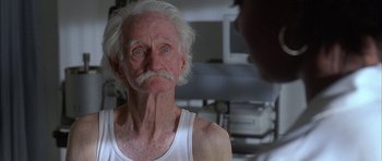 Movie still from “Breakin' All the Rules” (2004), directed by Daniel Taplitz – An old man with a white beard looking at the camera; Close Up shot, Low angle