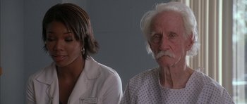 Movie still from “Breakin' All the Rules” (2004), directed by Daniel Taplitz – A man and a woman standing next to each other; Close Up shot, Over the shoulder angle