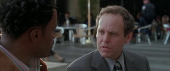 Movie still from “Breakin' All the Rules” (2004), directed by Daniel Taplitz – A man in a suit and tie talking to another man in a suit and tie; Close Up shot, Over the shoulder angle
