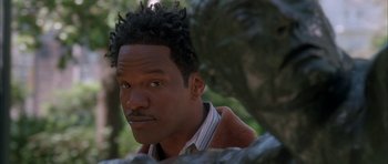 Movie still from “Breakin' All the Rules” (2004), directed by Daniel Taplitz – A person wearing a jacket near a tree; Close Up shot, High angle