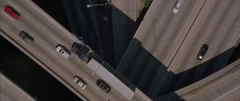Movie still from “Breakin' All the Rules” (2004), directed by Daniel Taplitz – An aerial view of a street with a car on it; Extreme Wide shot, Overhead angle