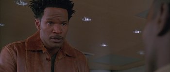 Movie still from “Breakin' All the Rules” (2004), directed by Daniel Taplitz – A person wearing a brown leather jacket; Close Up shot, High angle