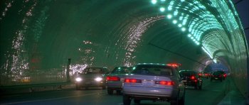 Movie still from “Breakin' All the Rules” (2004), directed by Daniel Taplitz – Cars driving through a tunnel in the dark; Extreme Wide shot, High angle