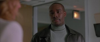 Movie still from “Breakin' All the Rules” (2004), directed by Daniel Taplitz – A man in a leather jacket looking at the camera; Close Up shot, Low angle