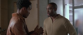 Movie still from “Breakin' All the Rules” (2004), directed by Daniel Taplitz – Two men talking to each other in a room; Medium shot, Over the shoulder angle