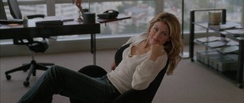 Movie still from “Breakin' All the Rules” (2004), directed by Daniel Taplitz – A woman sitting in a chair in front of a window; Medium shot, High angle