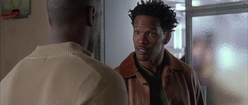 Movie still from “Breakin' All the Rules” (2004), directed by Daniel Taplitz – A man in a leather jacket talking to another man in a tie; Close Up shot, Over the shoulder angle