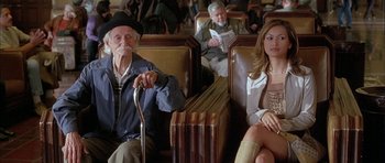Movie still from “Breakin' All the Rules” (2004), directed by Daniel Taplitz – A man and a woman sitting on a bench; Medium shot, Low angle
