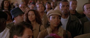 Movie still from “Breakin' All the Rules” (2004), directed by Daniel Taplitz – A group of people standing in a room; Close Up shot, High angle
