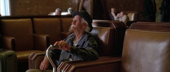 Movie still from “Breakin' All the Rules” (2004), directed by Daniel Taplitz – An old man sitting in a chair with a hat on; Medium shot, Low angle