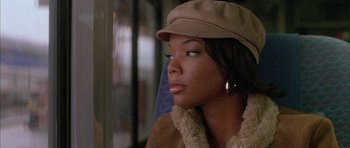 Movie still from “Breakin' All the Rules” (2004), directed by Daniel Taplitz – A black woman wearing a brown hat looking off into the distance; Close Up shot, High angle
