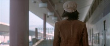 Movie still from “Breakin' All the Rules” (2004), directed by Daniel Taplitz – A woman wearing a brown coat and a hat; Medium shot, Low angle