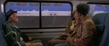 Movie still from “Breakin' All the Rules” (2004), directed by Daniel Taplitz – A group of people riding on a train; Medium shot, Over the shoulder angle