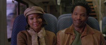 Movie still from “Breakin' All the Rules” (2004), directed by Daniel Taplitz – A man and a woman sitting next to each other on a train; Close Up shot, High angle