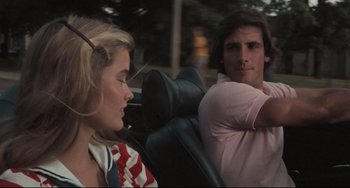 Movie still from “Breaking Away” (1979), directed by Peter Yates – A man and a woman sitting in the back of a car; Medium shot, Over the shoulder angle