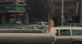 Movie still from “Breaking Away” (1979), directed by Peter Yates – A young woman standing on the side of the street; Wide shot, High angle