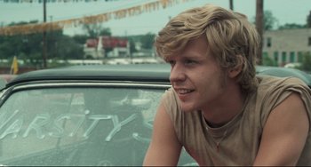 Movie still from “Breaking Away” (1979), directed by Peter Yates – A man sitting in the driver's seat of a car; Close Up shot, Over the shoulder angle