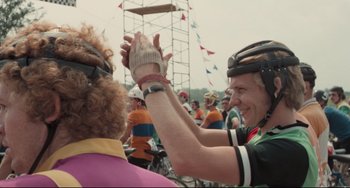 Movie still from “Breaking Away” (1979), directed by Peter Yates – A woman giving a high five to another person; Close Up shot, Over the shoulder angle