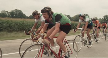 Movie still from “Breaking Away” (1979), directed by Peter Yates – A group of men riding bikes down a street; Medium shot, Low angle