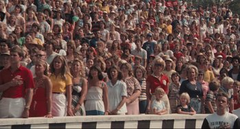 Movie still from “Breaking Away” (1979), directed by Peter Yates – A crowd of people standing in a stadium; Wide shot, High angle
