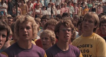 Movie still from “Breaking Away” (1979), directed by Peter Yates – A group of young men standing next to each other in a crowd; Medium shot, High angle