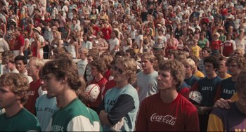 Movie still from “Breaking Away” (1979), directed by Peter Yates – A crowd of people are gathered together in a stadium; Medium shot, High angle