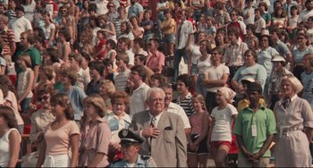 Movie still from “Breaking Away” (1979), directed by Peter Yates – A crowd of people standing in a stadium; Wide shot, High angle