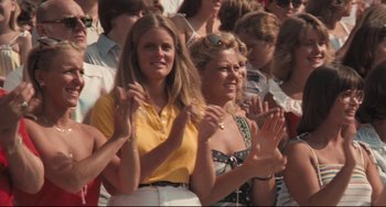 Movie still from “Breaking Away” (1979), directed by Peter Yates – A group of women clapping in front of a crowd; Medium shot, Low angle