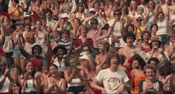 Movie still from “Breaking Away” (1979), directed by Peter Yates – A large group of people sitting in a stadium; Wide shot, High angle