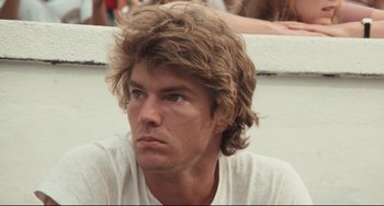 Movie still from “Breaking Away” (1979), directed by Peter Yates – A person wearing a white t - shirt; Close Up shot, Low angle
