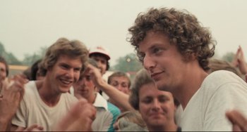 Movie still from “Breaking Away” (1979), directed by Peter Yates – A group of young men standing next to each other; Close Up shot, Over the shoulder angle