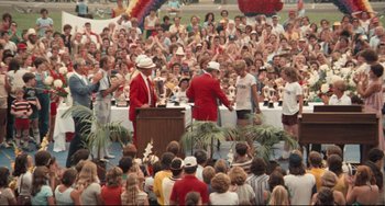 Movie still from “Breaking Away” (1979), directed by Peter Yates – A group of people standing in front of a crowd; Wide shot, High angle