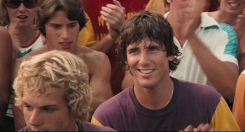 Movie still from “Breaking Away” (1979), directed by Peter Yates – A man that is sitting in a crowd of people; Close Up shot, Over the shoulder angle