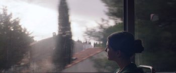 Movie still from “Breathe” (2014), directed by Mélanie Laurent – A woman looking out of a window at a park; Close Up shot, Low angle