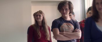 Movie still from “Breathe” (2014), directed by Mélanie Laurent – A man and a woman standing next to each other in a room; Medium shot, Over the shoulder angle