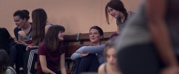 Movie still from “Breathe” (2014), directed by Mélanie Laurent – A group of women sitting on a bench; Medium shot, Over the shoulder angle