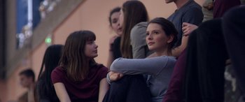 Movie still from “Breathe” (2014), directed by Mélanie Laurent – A group of young people sitting next to each other; Medium shot, Low angle