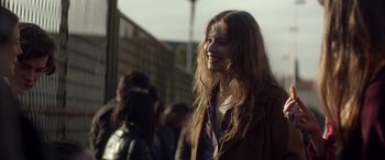 Movie still from “Breathe” (2014), directed by Mélanie Laurent – A woman with long red hair smiles at the camera; Medium shot, Over the shoulder angle