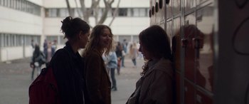 Movie still from “Breathe” (2014), directed by Mélanie Laurent – A group of women standing next to each other on a sidewalk; Medium shot, Over the shoulder angle