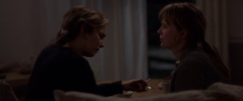 Movie still from “Breathe” (2014), directed by Mélanie Laurent – Two people sitting at a table looking at each other; Medium shot, Over the shoulder angle