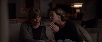 Movie still from “Breathe” (2014), directed by Mélanie Laurent – Two women sitting on a couch looking at each other; Medium shot, Over the shoulder angle