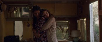 Movie still from “Breathe” (2014), directed by Mélanie Laurent – Two women hugging in a room with a window in the background; Medium shot, Low angle