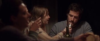Movie still from “Breathe” (2014), directed by Mélanie Laurent – A woman and a man sitting in front of a wine bottle; Medium shot, Over the shoulder angle