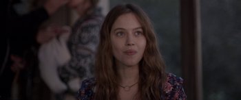 Movie still from “Breathe” (2014), directed by Mélanie Laurent – A woman with long brown hair wearing a necklace; Close Up shot, Over the shoulder angle