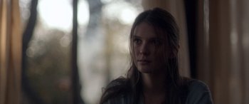 Movie still from “Breathe” (2014), directed by Mélanie Laurent – A woman with long brown hair stares into the distance; Close Up shot, Over the shoulder angle