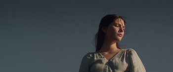 Movie still from “Breathe” (2014), directed by Mélanie Laurent – A woman standing in the sunlight with her eyes closed; Close Up shot, Low angle