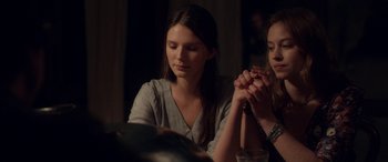 Movie still from “Breathe” (2014), directed by Mélanie Laurent – A woman sitting at a table with another woman; Medium shot, Over the shoulder angle