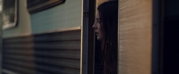 Movie still from “Breathe” (2014), directed by Mélanie Laurent – A woman looking out of a window at the outside; Close Up shot, Low angle
