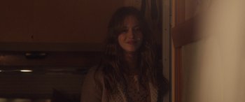 Movie still from “Breathe” (2014), directed by Mélanie Laurent – A woman with long hair is smiling for the camera; Medium shot, Over the shoulder angle